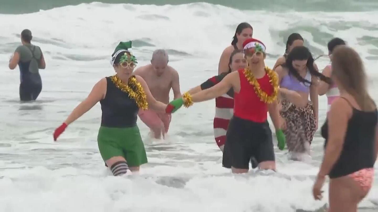 Portuguese swimmers celebrate new year with plunge into the Atlantic Ocean - AP News