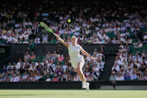 Wimbledon crowd keeps one eye on England's World Cup match